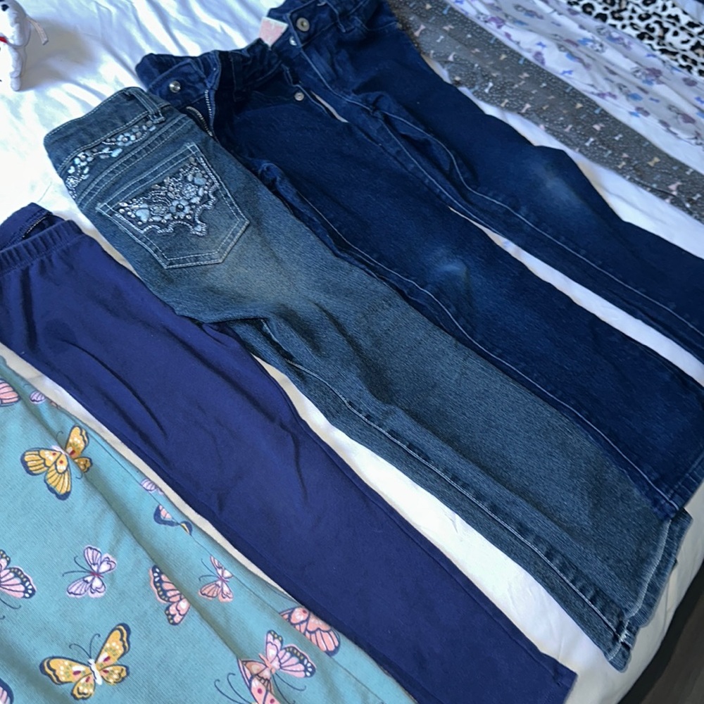 A bundle of 9 pairs of pants ranging in sizes 4, 4/5 & 5.